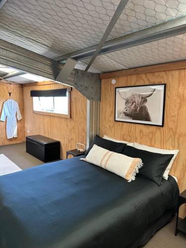 a bedroom with a blue bed in a room at Mount Jowett Retreat in Whanganui