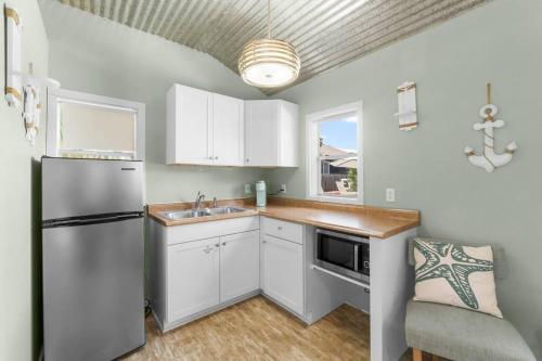 a kitchen with a white refrigerator and a sink at Making Memories in Panama City Beach