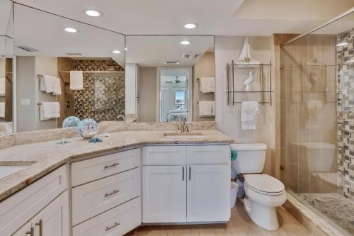 a bathroom with a toilet and a sink and a shower at Land's End 4-303 Bay Front - Premier in St Pete Beach