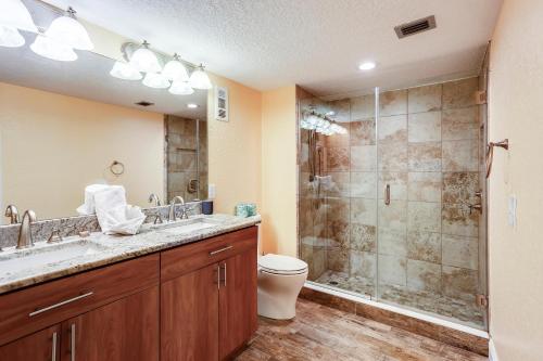 a bathroom with a shower and a sink and a toilet at Land's End 6-303 Beach Front - Premier in St Pete Beach