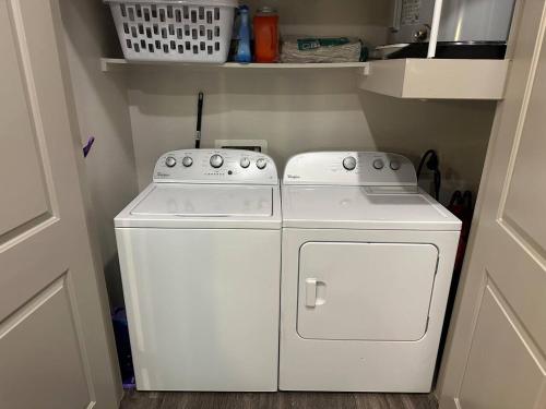 a small kitchen with a white washer and dryer at Luxurious 1 Bedroom w pool & patio inGalleria area in Houston