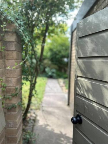 a door to a house with a walkway behind it at Relaxed and stylish -self check in, secure parking in Mount Clear