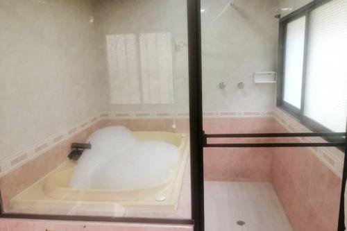 a bath tub in a bathroom with a window at Finca San Antonio del Tequendama in San Antonio del Tequendama