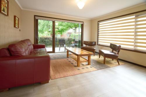 a living room with a couch and a table at Mirabosque New Apartments 1 in Osorno