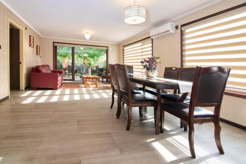 a dining room with a table and chairs at Mirabosque New Apartments 1 in Osorno