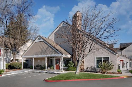a house with a tree in front of it at Residence Inn Fremont Silicon Valley in Fremont