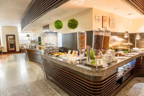 a restaurant with a buffet line with food at Sheraton Guayaquil in Guayaquil
