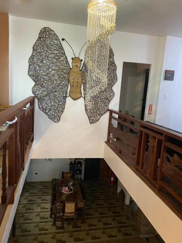 a butterfly sculpture on the wall of a room at Koa's Beach House in Tangalan