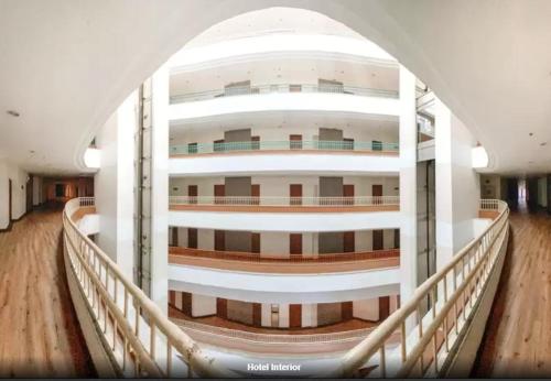 a large building with a balcony and a hallway at Loei Palace Hotel in Loei
