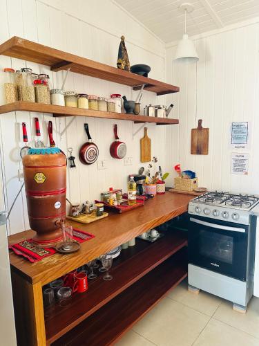 a kitchen with a counter with a stove and a counter top at MAKTVB - EcoLodge San Pedro de Atacama in San Pedro de Atacama