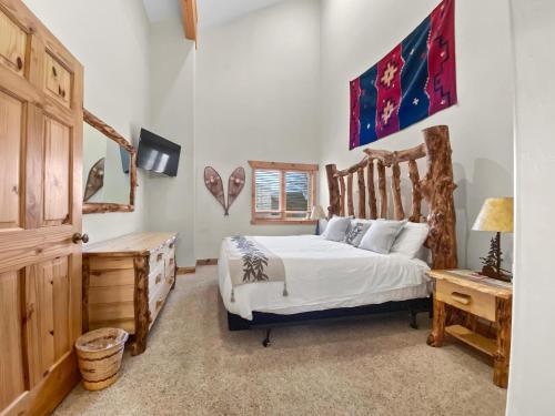 a bedroom with a bed and a wooden headboard at 6 A Timberwolf Lodge by SkyRun Park City in Park City
