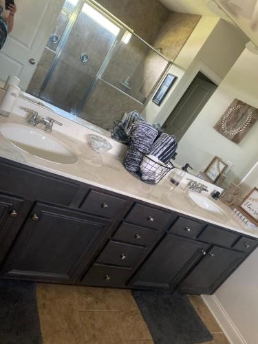 Un baño con dos lavabos y un espejo grande. en Cozy Bedroom in Newer Home, en Cartersville