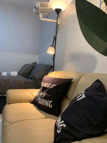 a living room with a couch with pillows on it at Gray Room The White Haven In Clark in Angeles