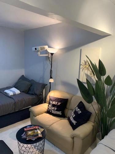 a living room with a couch and a chair at Gray Room The White Haven In Clark in Angeles
