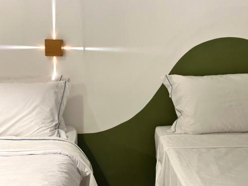 two beds sitting next to each other in a bedroom at Pousada Vilab in Arraial d'Ajuda