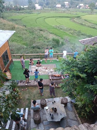 a group of people standing around in a yard at Moc's House bắc hà in Bắc Hà