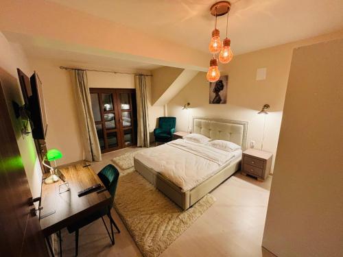 a bedroom with a bed and a desk with a computer at Mellis Boutique in Cluj-Napoca