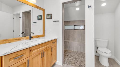 a bathroom with a sink and a toilet and a mirror at Diamond Peak - Unit 20 in Sunriver