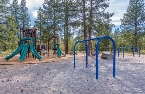 a playground with a slide and a swing set at Towhee - Unit 5 in Sunriver