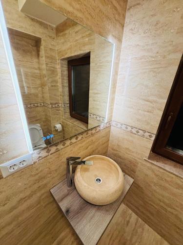 a bathroom with a wooden sink and a mirror at Mellis Boutique in Cluj-Napoca