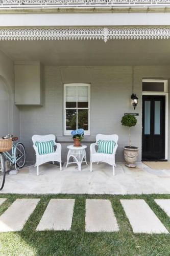 two white chairs and a table on a patio at Little Terrace Bowral 1 in Bowral