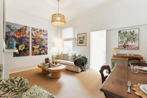 a living room with a couch and a table at Little Terrace Bowral 1 in Bowral