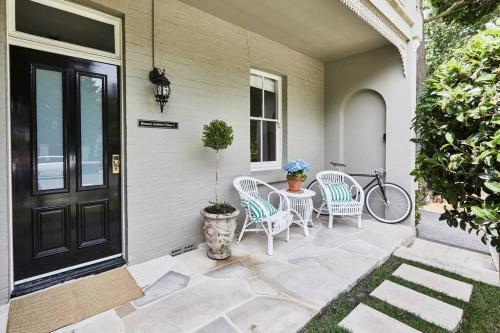 a patio with two chairs and a table and a bike at Little Terrace Bowral 1 in Bowral