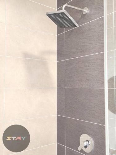 a shower stall with a glass door with a shower at DP Warm Sunshine Family Netflix Legoland By STAY in Iskandar Puteri