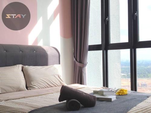 a bedroom with a bed with a large window at DP Warm Sunshine Family Netflix Legoland By STAY in Iskandar Puteri