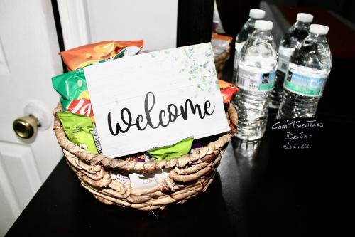 a welcome basket with bottles of water on a table at Private Room C West NY, NJ 12 mints from NYCit in West New York