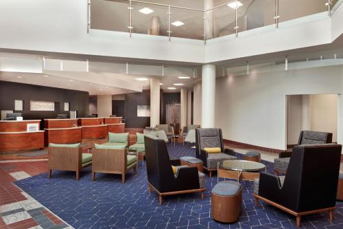 a lobby with chairs and tables and a waiting room at Courtyard by Marriott Ottawa East in Ottawa