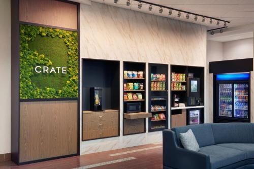 a coffee shop with a blue couch in a lobby at Courtyard by Marriott Ottawa East in Ottawa
