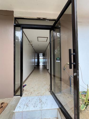 an elevator corridor in an office building with glass doors at Dandal Bay View Inn in Nacpan