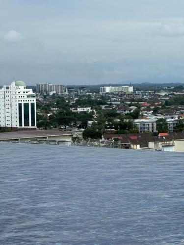 a large body of water with a city in the background at The Podium, Kuching in Kuching