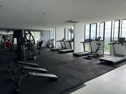 a gym with a bunch of treadmills and machines at The Podium, Kuching in Kuching