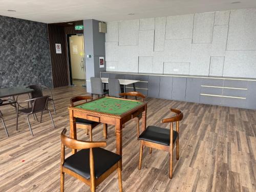 a room with a ping pong table and chairs at The Podium, Kuching in Kuching