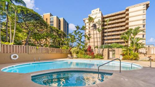 a swimming pool in a building with trees and buildings at Maui Kai 808 · MK 808 OceanFront 1BD Kaanapali Beach Ocean Views in Lahaina