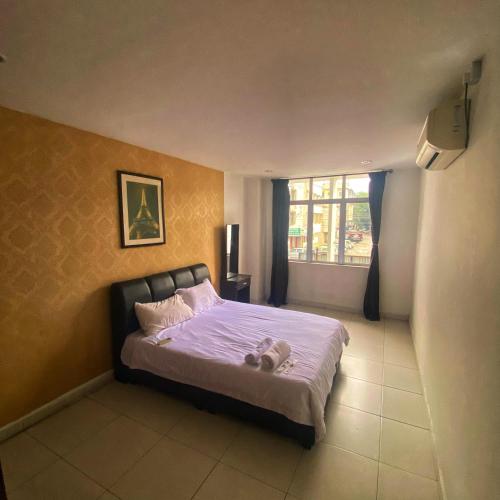 a bedroom with a bed with a teddy bear on it at Ipoh Apartment Suites in Ipoh