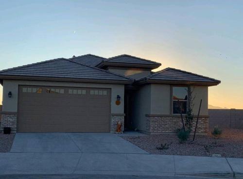 a house with a garage in front of it at Lovely white grey home 3 bedrooms in Buckeye