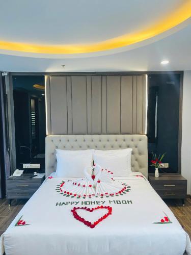a white bed with a heart decoration on it at Le Anh Hotel in Phu Quoc