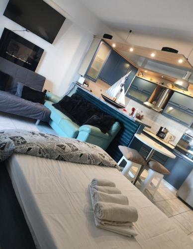 a bedroom with a large bed and a living room at Ελένη in Megalochori