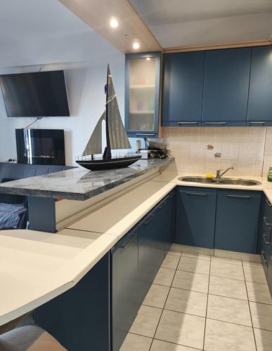 a kitchen with a toy sailboat on the counter at Ελένη in Megalochori