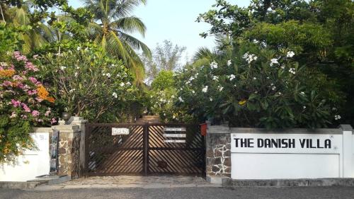 a gate with a sign that reads the danish villa at The Danish Villa Resort in Arugam Bay