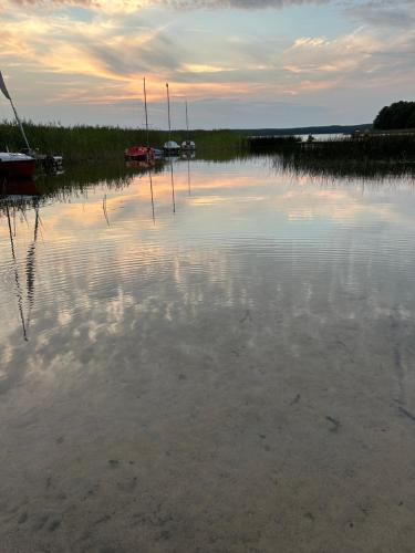 a large body of water with boats in it at Mazury Dom Oskar nad jeziorem Sasek Wielki z jakuzzi in Szczytno