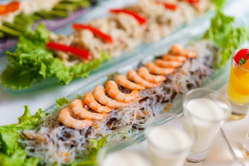 a buffet line of food with shrimp and lettuce at The Beach Tower Okinawa in Chatan