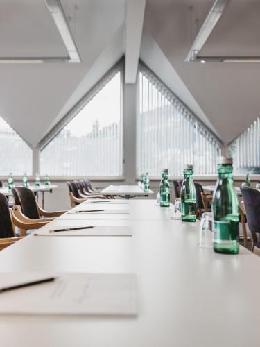 a long table in a room with green bottles on it at Sporthotel Royer in Schladming