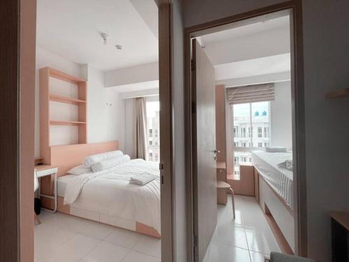 a bedroom with a bed and a large window at Bangulbobo 2br tower Ishikawa in Sungaitahang