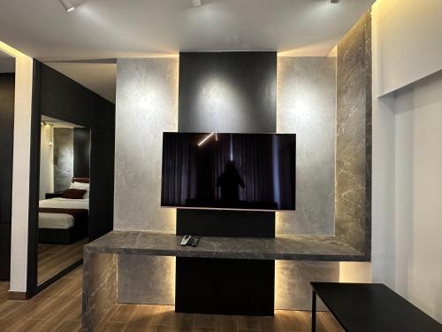 a living room with a television on a wall at Foy's Lake Resort in Chittagong
