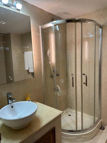 a bathroom with a shower and a sink and a sink at Foy's Lake Resort in Chittagong