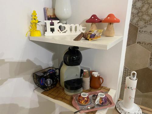 a shelf with a coffee maker on it at Eterea Casa Vacanza in Brindisi